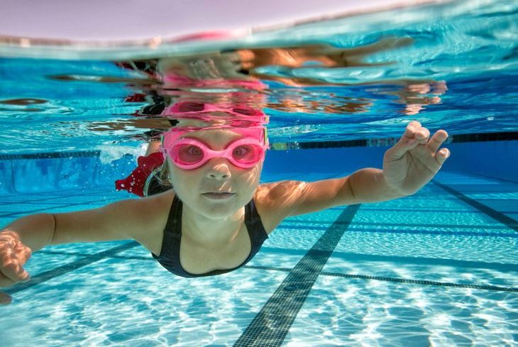 Child swimming in a crystal-clear pool